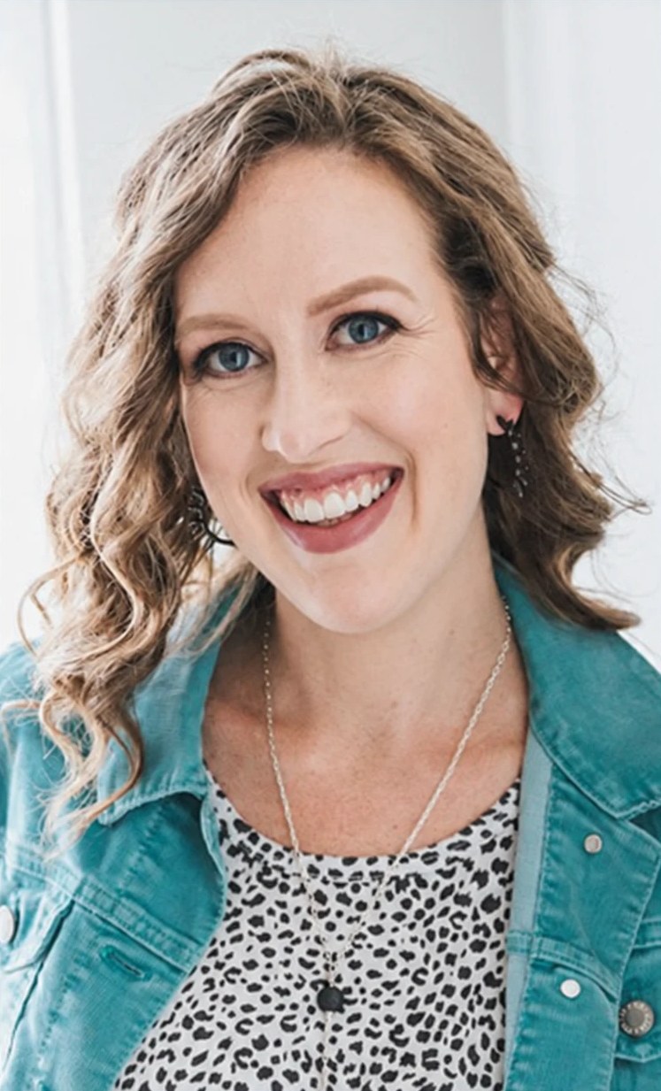 Kacey Birch, lifecycle and conversion strategist, smiling in a teal jacket